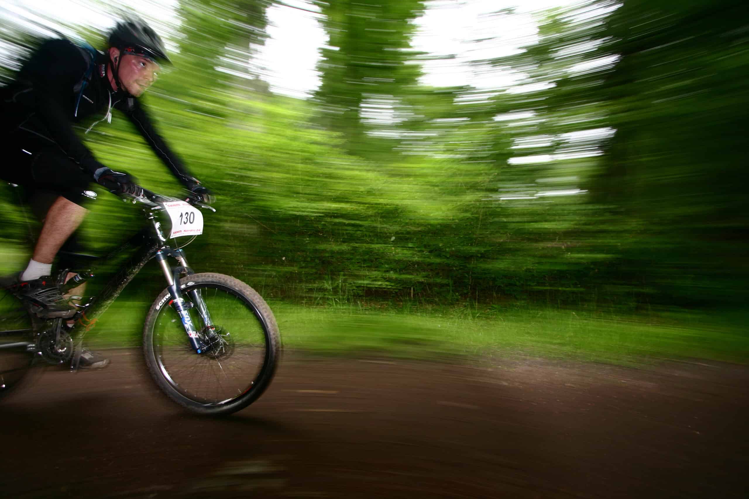 mountain bike race in a forest in denmark,  Shot with low shutter speed to achieve motion blur